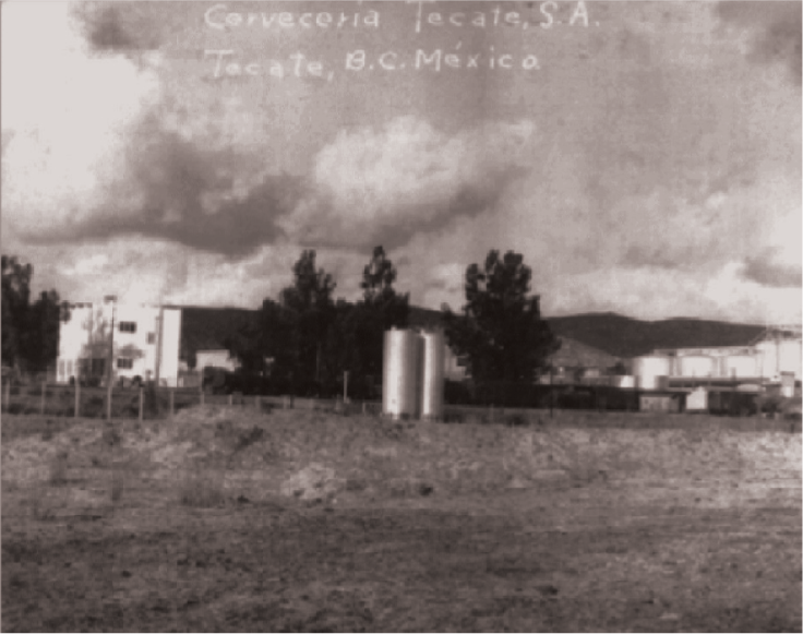 Sepia old picture of Tecate® brewery from a field in Tecate Baja California. Metal containers seen.